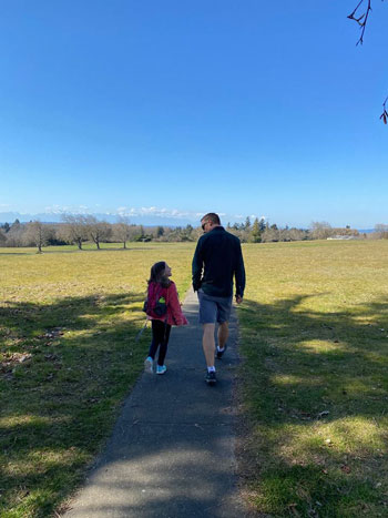 Father and daughter walking on a path