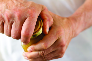 Strong Male Hands Twisting a Stubborn Jar Lid 