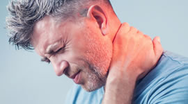 Man holding neck displaying neck pain