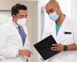 Dr. Theodore Wolfson, M.D. (left) reviewing patient case information with team member